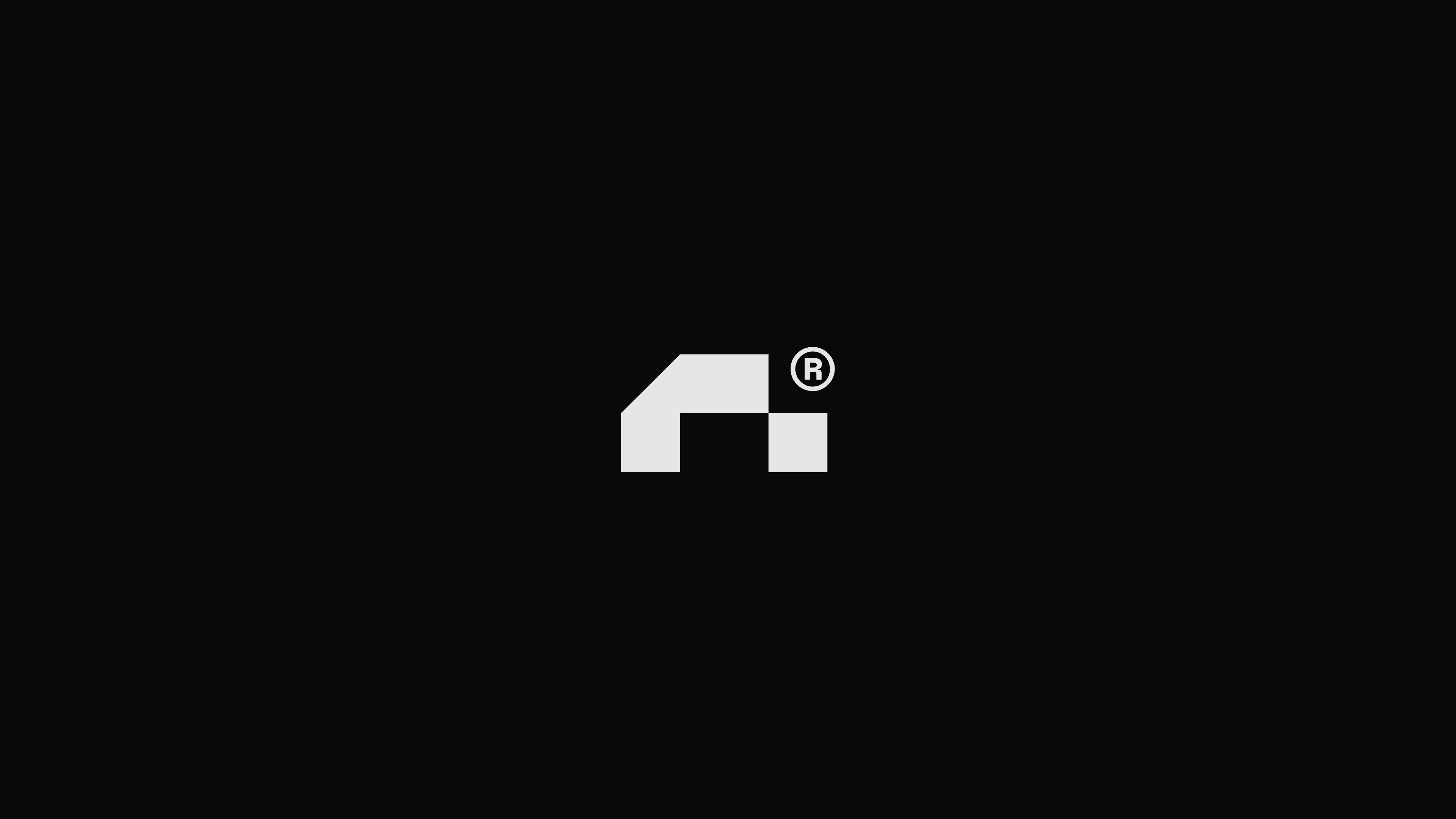 Centered Runreal logo mark on a black background, designed by Kundo Studio to showcase the minimal, tech-forward brand identity for the Unreal Engine developer platform.
